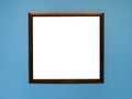 Narrow brown flat wood picture frame on blue wall Royalty Free Stock Photo