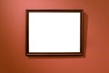 Narrow brown wooden picture frame on dark red wall Royalty Free Stock Photo