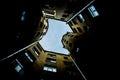 Narrow buildings well in Saint-Petersburg with the sky above the roofs. Below view.