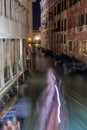 Narrow canal with boats and vintage houses at dusk. Venice city at night Royalty Free Stock Photo