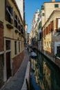 Narrow canal among old colorful brick houses in Venice, Royalty Free Stock Photo