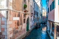 Narrow canal among old colorful brick houses in Venice, Italy Royalty Free Stock Photo