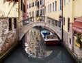 Narrow canal among old houses in Venice