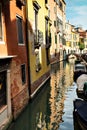 Narrow canal waterway with colourful colorful houses boats and bridge, Burano, venice, Italy Royalty Free Stock Photo