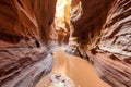 a narrow cave passage with sandy floor