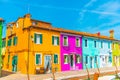 Narrow street with blue, red, green and purple house facade in the island of Burano, Venice Royalty Free Stock Photo
