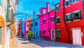 Blue, red, green and purple house facade in the island of Burano, Venice