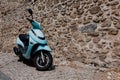 Narrow cobbled historical streets of Rhodes. Vintage scooter bike is parked old stone against wall of house, Rhodes