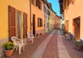 Narrow cobbled street among colorful houses in Italy. Royalty Free Stock Photo