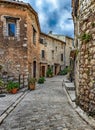 Narrow cobbled street with flowers in the old village , France Royalty Free Stock Photo