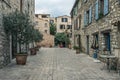 Narrow cobbled street with flowers in the old village Tourrettes-sur-Loup , France. Royalty Free Stock Photo