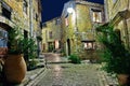 Narrow cobbled street with flowers in the old village Royalty Free Stock Photo