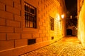 Narrow cobbled street illuminated by street lamps of Old Town, Prague, Czech Republic Royalty Free Stock Photo