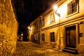 Narrow cobbled street in old medieval town with illuminated houses by vintage street lamps, Novy svet, Prague, Czech Royalty Free Stock Photo