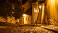 Narrow cobbled street in old medieval town with illuminated houses by vintage street lamps, Novy svet, Prague, Czech Royalty Free Stock Photo