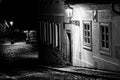 Narrow cobbled street in old medieval town with illuminated houses by vintage street lamps, Novy svet, Prague, Czech Royalty Free Stock Photo