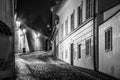 Narrow cobbled street in old medieval town with illuminated houses by vintage street lamps, Novy svet, Prague, Czech Royalty Free Stock Photo