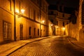 Narrow cobbled street in old medieval town with illuminated houses by vintage street lamps, Novy svet, Prague, Czech Royalty Free Stock Photo