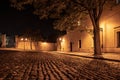 Narrow cobbled street in old medieval town with illuminated houses by vintage street lamps, Novy svet, Prague, Czech Royalty Free Stock Photo