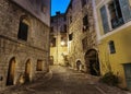 Narrow cobbled street in old town Peille at night. Royalty Free Stock Photo