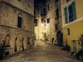 Narrow cobbled street in old town Peille at night. Royalty Free Stock Photo