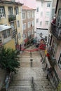 Narrow cobbled street with steps in Lisbon Royalty Free Stock Photo