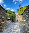 Narrow cobbled street with stone houses