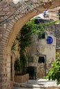 Narrow cobbled street among traditional stoned houses of jewish quarter at old historic part of jerusalem, Israel