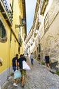 Narrow cobblestone alley with a steep slope and facades of old houses in the center of Porto Portugal Royalty Free Stock Photo