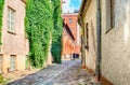 Narrow cobblestoned narrow street in Riga, Latvia during sunny day. Old Town of Riga. Royalty Free Stock Photo
