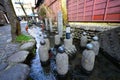 Narrow and cobblestoned Yanaka Lane with a canal along it in Gujo, Japan