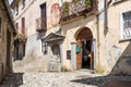 Narrow cobblestones streets with paintings on walls in ancient painted village Arcumeggia in province of Varese, Italy