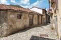 Narrow cobblestones streets with paintings on walls in ancient painted village Arcumeggia in province of Varese, Italy