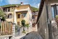 Narrow cobblestones streets with paintings on walls in ancient painted village Arcumeggia in province of Varese, Italy