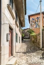 Narrow cobblestones streets with paintings on walls in ancient painted village Arcumeggia in province of Varese, Italy