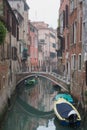 The narrow colorful street with a boat in Venice, Italy. Scenic beautiful view of Venice canal with reflection in the water Royalty Free Stock Photo