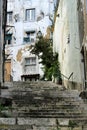 Narrow and colorful streets of Lisbon in a cloudy day Royalty Free Stock Photo