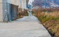 Narrow concrete roadway along side an overpass