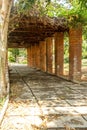 Narrow cross view of red brick pillar pathway in a garden, Chennai, India, April 1st 2017