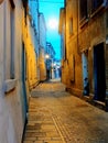 Narrow and curved street. Desert and lonely scenery. It\'s almost night in the small town of Europe. Royalty Free Stock Photo