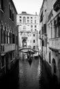 Narrow dark streets of Venice. Water. Black and white.