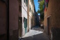 Narrow European street with scooters parked and clothes drying on clothes line Royalty Free Stock Photo