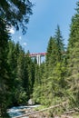 Narrow gauge train crosses a long viaduct across a deep canyon in the Swiss Alps Royalty Free Stock Photo