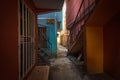 Narrow Hallway Between Multi-Storey Apartments with Exterior Staircases