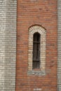 Narrow high arched window in a brick wall, background Royalty Free Stock Photo