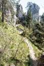 Narrow hiking trail in spring mountains with limestone rocks