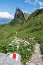 Gravel hiking path on the Swiss Alps Stockhorn and Solhore peak, marked by a red and white bars