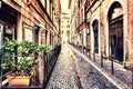 Narrow Italian street with a cozy cafe terrace in a fashionable part of Rome