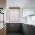 Narrow kitchen with gray unit Royalty Free Stock Photo