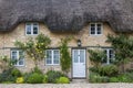 Narrow lane with romantic thatched houses and stone cottages in the lovely Minster Lovell village, Cotswolds, Oxfordshire